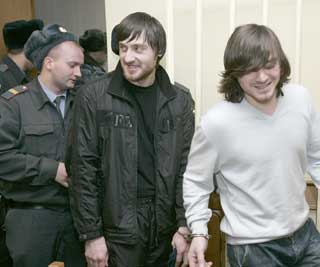 Defendants in the Politkovskaya murder walk out of court after their recent acquittal.  (Reuters)
