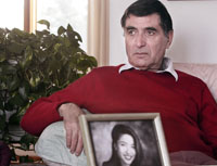 Reza Saberi holds a picture of his daughter Roxana. (AP)