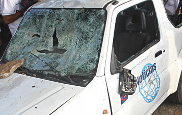 A news vehicle was targeted by vandals during election unrest. (AP)