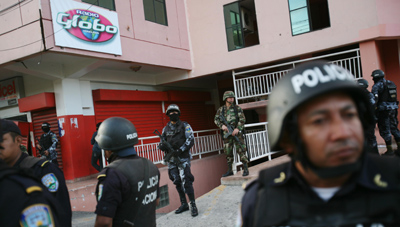 Police outside Radio Globo. (AP)