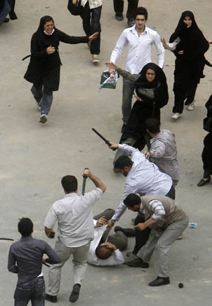 Security agents in Tehran beat a demonstrator in the aftermath of the contested June elections. (AFP)