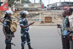 Riot police confront journalists in Libreville during an August opposition protest. (Andriankoto Ratozamanana)