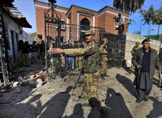 Soldiers secure the Peshawar Press club after a suicide bombing in December. (Reuters/Fayaz Aziz)