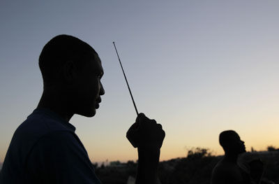 A Haitian refugee in a Port-au-Prince camp listens to the radio. (AP)