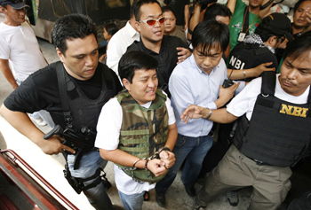 Andal Ampatuan Jr., a local mayor and chief suspect in the Maguindanao massacre, is led into court in Manila. (AP)