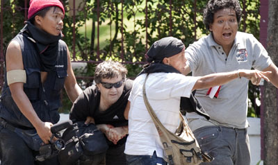 Protesters help Nelson Rand after the France 24 journalist was shot during unrest in Bangkok. (Reuters/Adrees Latif)