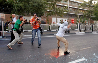 Iranian photographer Mohammad Kheirkhan, left, documents protests in Tehran. Kheirkhan was forced into exile. (Payam Borazjani)