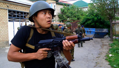 Kyrgyz Interior Ministry forces conduct house-to-house searches in the city of Osh, southern Kyrgyzstan, today. (AP)