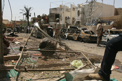 Iraqi soldiers outside Al-Arabiya's office in central Baghdad after a suicide bombing today. (Ali Al-Saadi/AFP)