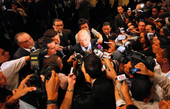 The OAS can play a key role in reversing abuses in Honduras. OAS Secretary-General José Miguel Insulza speaks with reporters in Tegucigalpa. (AP/Eduardo Verdugo)