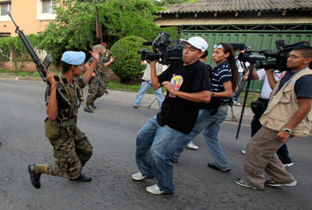 Soldiers block journalists from filming near the presidential palace in Tegucigalpa following the June 2009 coup. The government censored and obstructed news outlets after President Zelaya was ousted. (AP/Esteban Felix)