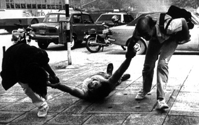 Colleagues try to pull NBC soundman Bill Latch to safety during violence in Bangkok 25 years ago. Latch and correspondent Neil Davis died in the unrest. (Reuters)