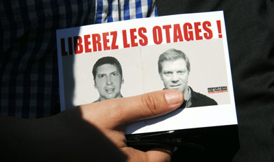 'Free the hostages!' is the rallying cry for those seeking the release of Hervé Ghesquière, left, and Stéphane Taponier, who were kidnapped in Afghanistan. (AFP/Michel Gangne)