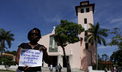 A woman in Havana holds a sign that reads: "My support will be eternal for freedom and justice" at a weekly march by members of the Cuban dissident group Ladies in White. (AP)