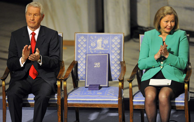 Members of Nobel Peace Prize committee flank a chair left empty for Nobel Peace Prize winner Liu Xiaobo, who remains jailed in China. (Toby Melville/Reuters)