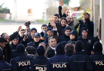 Two leading investigative journalists, Ahmet Sik, far left, and Nedim Sener, center, arrive at court in Istanbul. (AP/Ozan Guzelce, Milliyet)