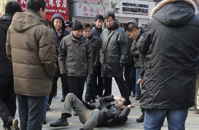 International journalists are targeted in many ways in China. Here, a foreign journalist is pushed to the ground while trying to cover a potential protest in Beijing. (Reuters)