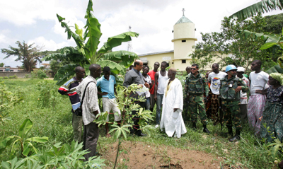 U.N. investigators check a reported mass grave in Yopougon, where one journalist was said to be buried. (UN/AP)