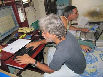 Febles, in back, and colleague Luis Cino work in the makeshift newsroom of Primavera Digital. (Courtesy Febles)