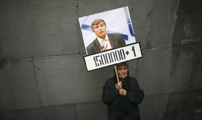 Hrant Dink, in the poster here, was a controversial journalist who challenged the government's narrative on the killings of Armenians. (Reuters)