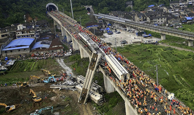 Chinese rescue workers by the wreckage of train cars in Wenzhou on Sunday. (AP/Color China Photo)