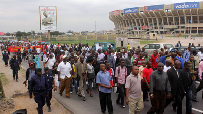 Marchers urge ruling party to end abuse. (John Bompengo)