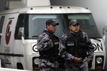 Police guard Gama TV after a government takeover. (Dolores Ochoa/AP)