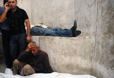 A man grieves near the shrouded bodies of protesters killed during clashes with Egyptian security forces in Cairo Sunday. (AP)