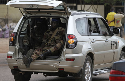 Pro-Ouattara FRCI soldiers patrol along a road in Yopougon. (Reuters).