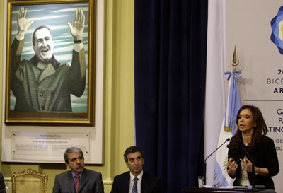 President Kirchner addresses the nation in August, 2010 near a painting of former President Juan Domingo Perón. (AP/Eduardo Di Baia)