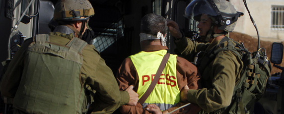 Journalists reporting on protests and civil unrest face a rising threat of detention. Here, Israeli soldiers arrest   a Palestinian journalist. (Reuters)