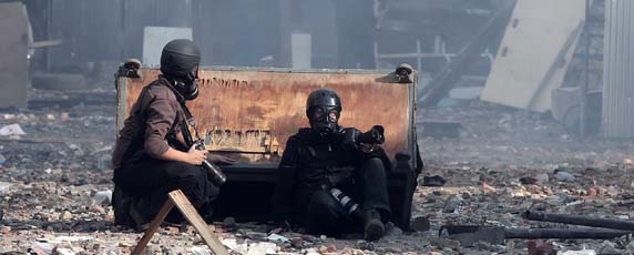 Photographers take cover during November protests in Tahrir Square. (AFP/Mahmud Hams)