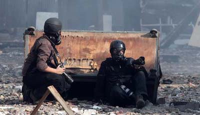 Photographers take cover during November protests in Tahrir Square. (AFP/Mahmud Hams)