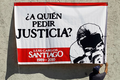 A banner seeks justice for  photographer Luis Carlos Santiago, whose case is among 11 unsolved murders over the past decade. (Reuters/Tomas Bravo)