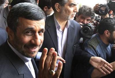 President Mahmoud Ahmadinejad has a wave and a smile for the media, even as his government imprisons journalists under horrific conditions. (AP/Vahid Salemi)
