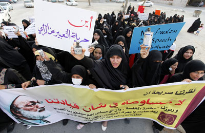 Protesters hold tear-gas canisters at an anti-U.S. protest held to condemn the sales of arms to Bahrain, in the village of Diraz west of Manama Thursday. Reuters/Hamad I Mohammed)