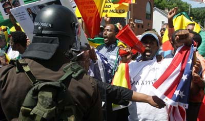 Police try to restrain Ethiopian demonstrators protesting near the G8 Summit at Camp David over the weekend. (AP/Timothy Jacobsen)