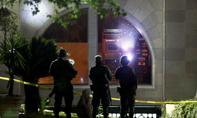 Soldiers stand in front of the offices of a news outlet that was attacked early Tuesday morning. (AFP/Julio Cesar Aguilar)