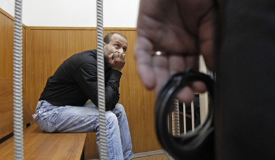 Retired police lieutenant colonel Dmitry Pavlyuchenkov, seen here in detention in 2011, was indicted in the Politkovskaya murder today. (Reuters/Sergei Karpukhin)