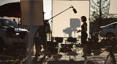 A TV crew reports on the shooting in Colorado from a parking lot across the street. (AFP/Getty Images/Chip Somodevilla)