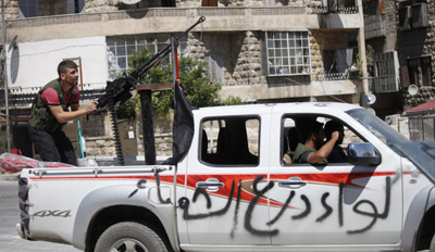 A rebel fighter trains an anti-aircraft machine gun in Aleppo. (Reuters/Zain Karam)