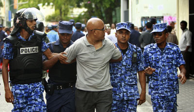 A protester is arrested during ongoing demonstrations in Male. (AP/Sinan Hussain)