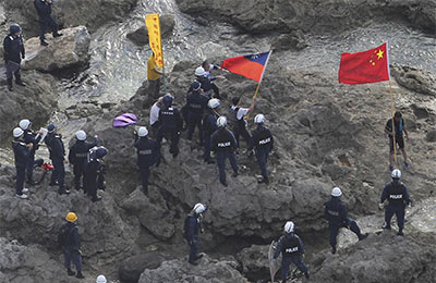 The Taiwanese flag was obscured or erased in some Chinese publications that published photos like this one, of activists being arrested by Japanese police as they  landed on islands claimed by China, Japan, and Taiwan. (AP/Yomiuri Shimbun, Masataka Morita)