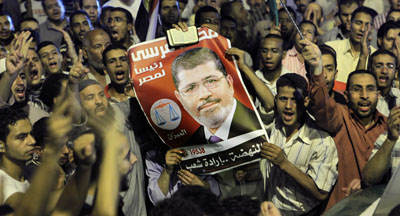 Supporters raise a photo of President Morsi. (AP/Amr Nabil)
