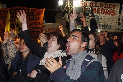 Government supporters celebrate the passage of the broadcast law outside the National Congress building in Buenos Aires, Oct. 10, 2009. (AP/Alberto Raggio)