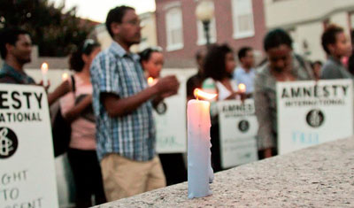 People gather at a candlelight vigil to commemorate the first anniversary of the arrest of imprisoned blogger Eskinder Nega. (George Newcomb)