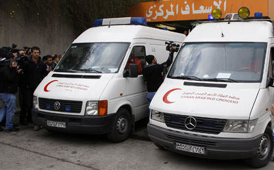 Ambulances carry the bodies of Marie Colvin and Rémi Ochlik, who were killed in government shelling in Syria. (Reuters/Khaled al-Hariri)