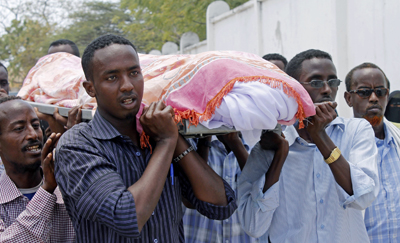 Des journalistes somaliens emportent la dépouille de leur confrère Abdisatar Sabriye Dahir, qui a été assassiné dans un café à Mogadiscio en Septembre. (AFP/Mohamed Abdiwahab)