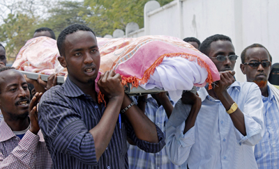 Somalis carry the body of journalist Abdisatar Dahir Sabriye, who was killed in an attack at a Mogadishu café in September. (AFP/Mohamed Abdiwahab)