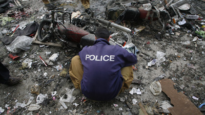 A bomb disposal officer checks the site of today's blast in Quetta, where at least two journalists were killed. (Reuters/Naseer Ahmed)